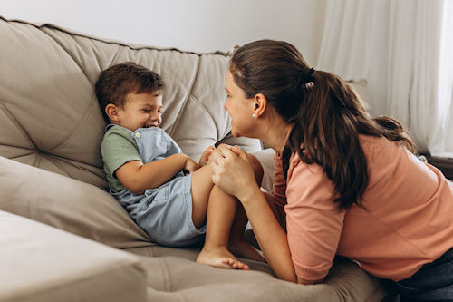 Woman playing with a little boy